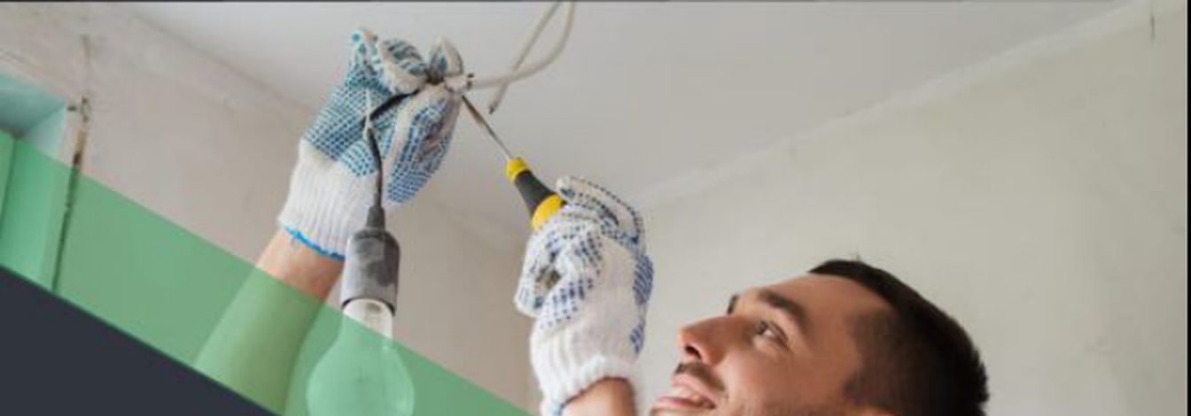Electrician installing a light bulb